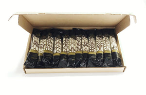 Twelve Hazelnut Zebra Be-Bop Biscotti, laying in an open, brown corrugated box. The biscotti are dipped in white chocolate icing and finished decoratively with a dark chocolate icing design.